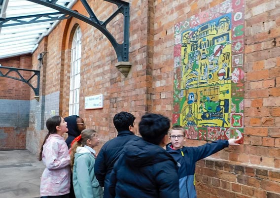 Pupils from St. George’s Church of England Primary School, Worcester, admiring their finished artwork.